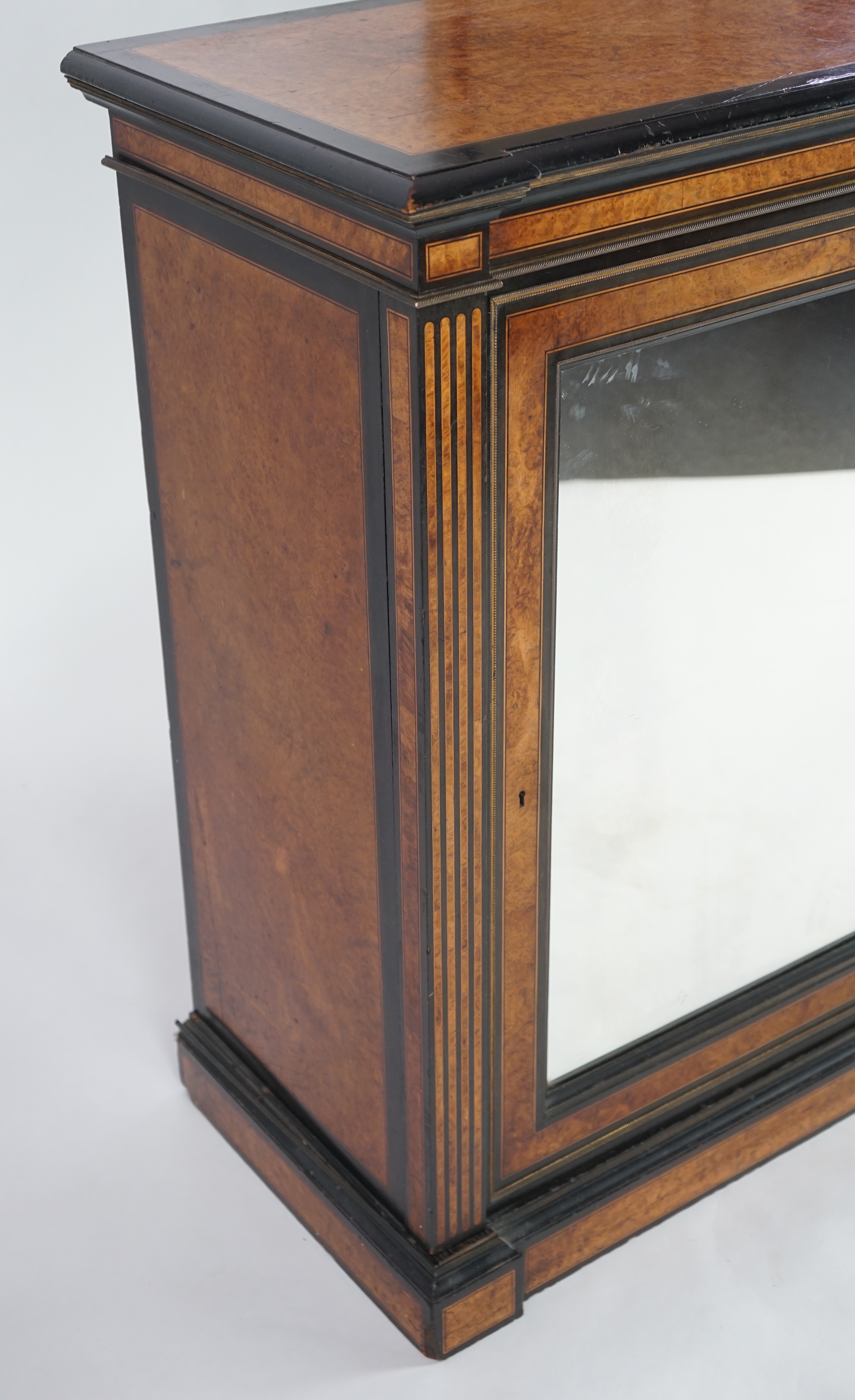 A Victorian ebony banded amboyna wood collector's cabinet, by Holland & Sons, with inverted breakfront top and single mirrored door enclosing four frieze and two banks of thirteen graduated drawers fitted with recessed b